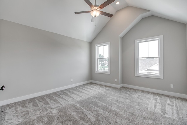 empty room with carpet, ceiling fan, and lofted ceiling