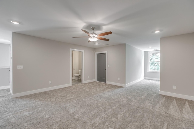 carpeted spare room with ceiling fan