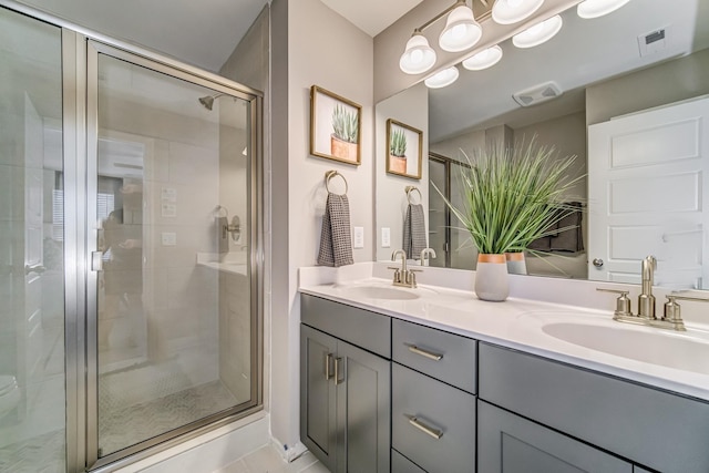 bathroom with vanity and a shower with shower door