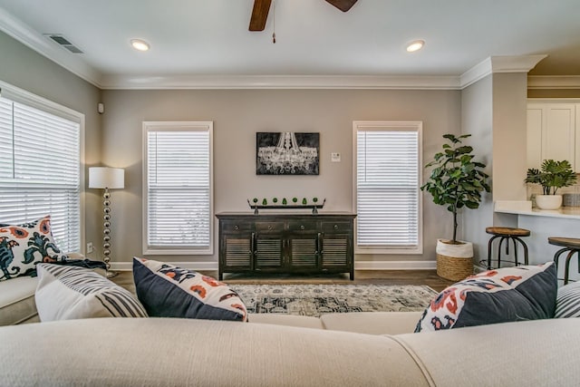 living room featuring ornamental molding, a healthy amount of sunlight, and hardwood / wood-style flooring