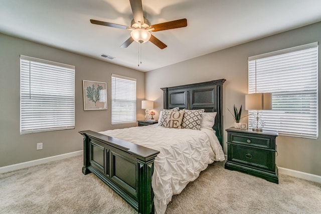 bedroom featuring light colored carpet and ceiling fan