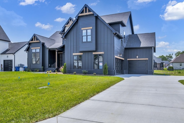 view of front of property featuring a garage and a front lawn