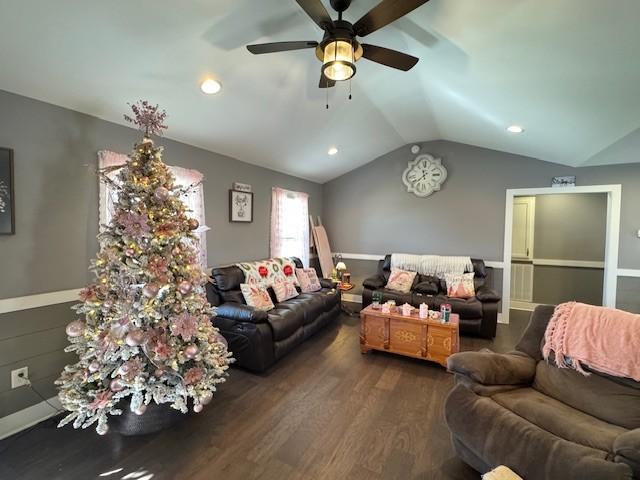 living room with dark hardwood / wood-style flooring, ceiling fan, and lofted ceiling