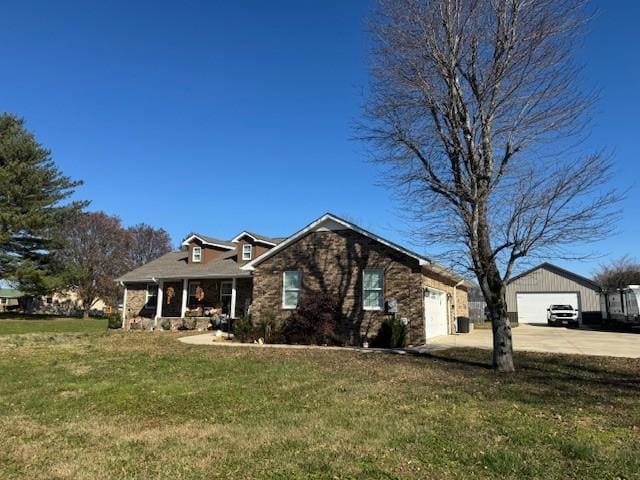 view of front facade featuring a porch, a garage, and a front yard