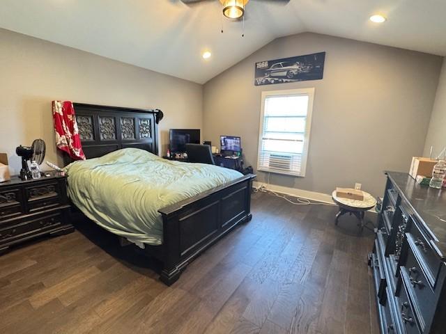 bedroom with vaulted ceiling, ceiling fan, and dark wood-type flooring