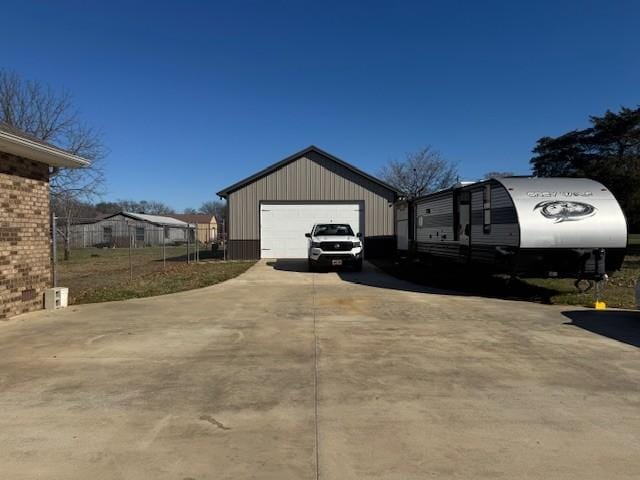 view of side of property featuring a garage and an outdoor structure