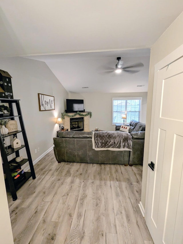 living room featuring ceiling fan and light wood-type flooring