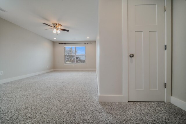 empty room featuring ceiling fan and carpet floors