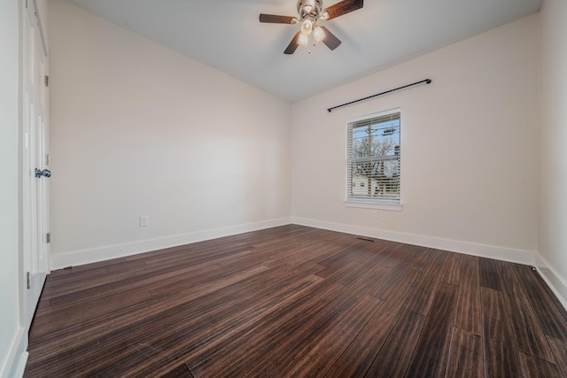 unfurnished room with dark hardwood / wood-style floors, vaulted ceiling, and ceiling fan