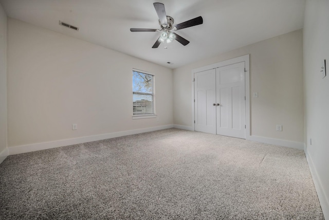 unfurnished bedroom featuring carpet, a closet, and ceiling fan