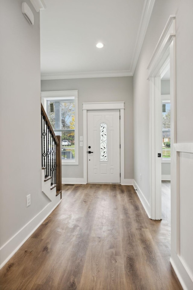 foyer entrance with hardwood / wood-style floors and ornamental molding