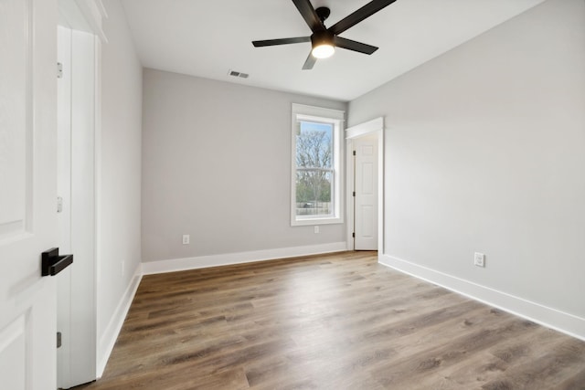 empty room featuring hardwood / wood-style floors and ceiling fan