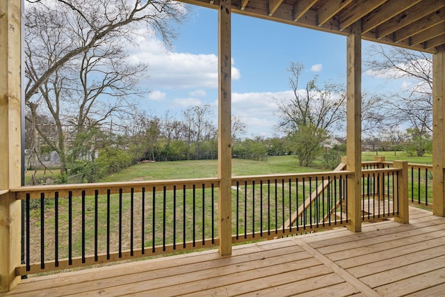 wooden terrace featuring a yard