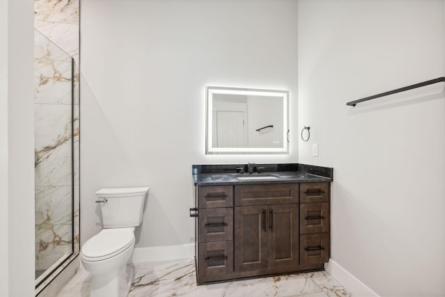 bathroom featuring an enclosed shower, vanity, and toilet