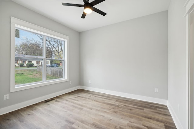 unfurnished room featuring ceiling fan and hardwood / wood-style flooring