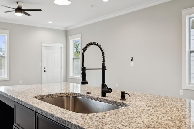 kitchen with ceiling fan, sink, and ornamental molding