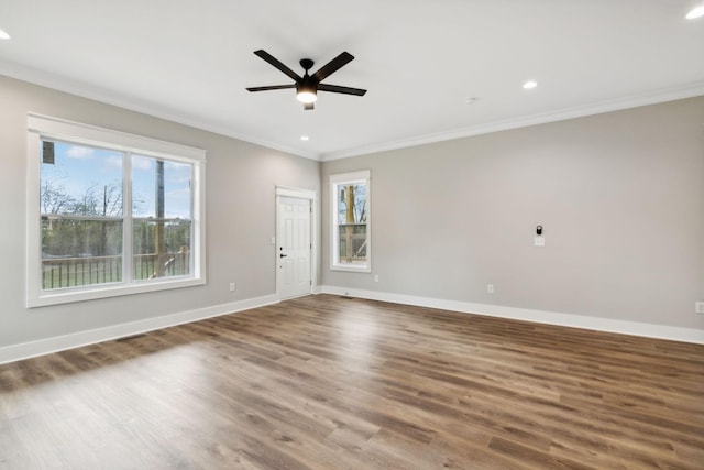 spare room with dark hardwood / wood-style floors, ceiling fan, and crown molding