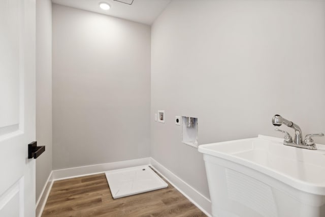 clothes washing area featuring hardwood / wood-style floors, hookup for an electric dryer, sink, and hookup for a washing machine