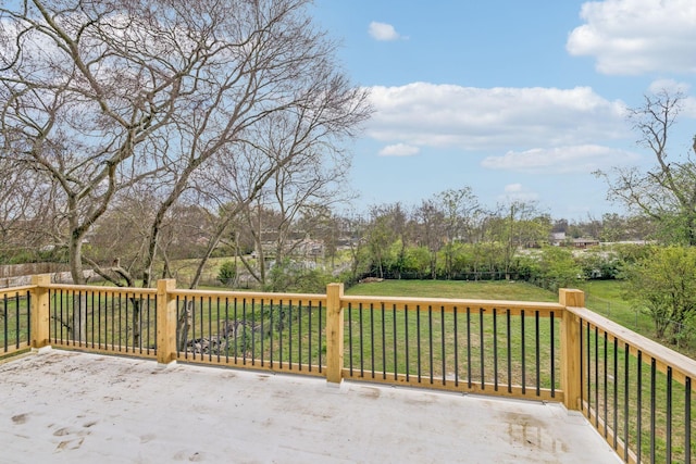 wooden deck featuring a lawn