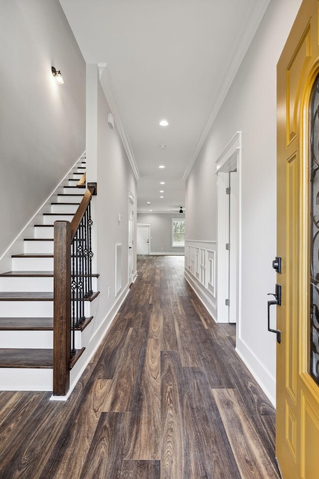 corridor with dark hardwood / wood-style floors and ornamental molding