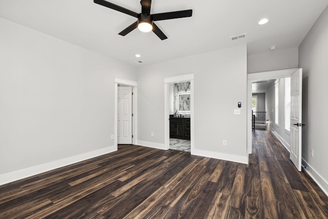 interior space with ensuite bath, ceiling fan, and dark hardwood / wood-style floors