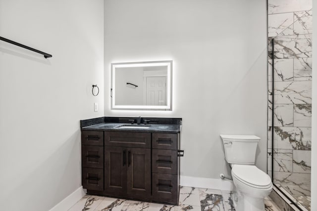 bathroom featuring vanity, toilet, and a tile shower