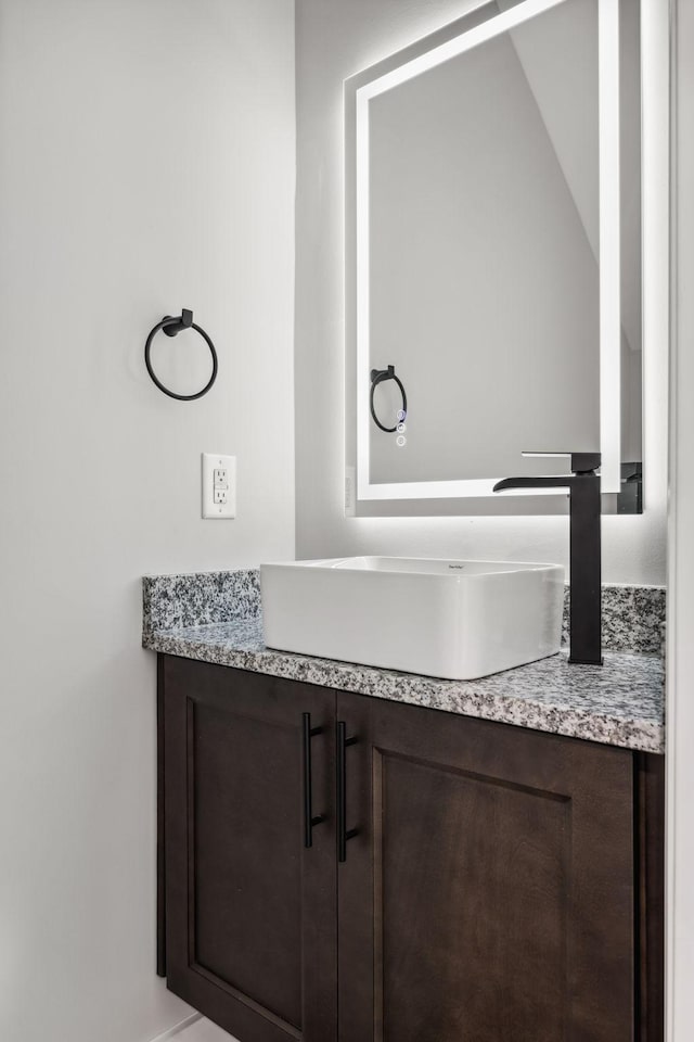 bathroom with vanity and vaulted ceiling