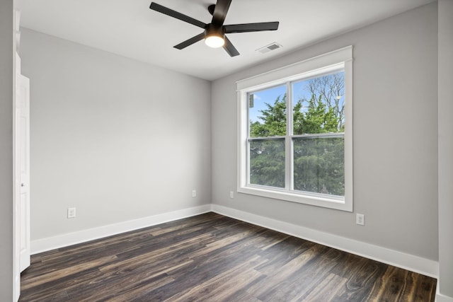 empty room with ceiling fan and dark hardwood / wood-style floors