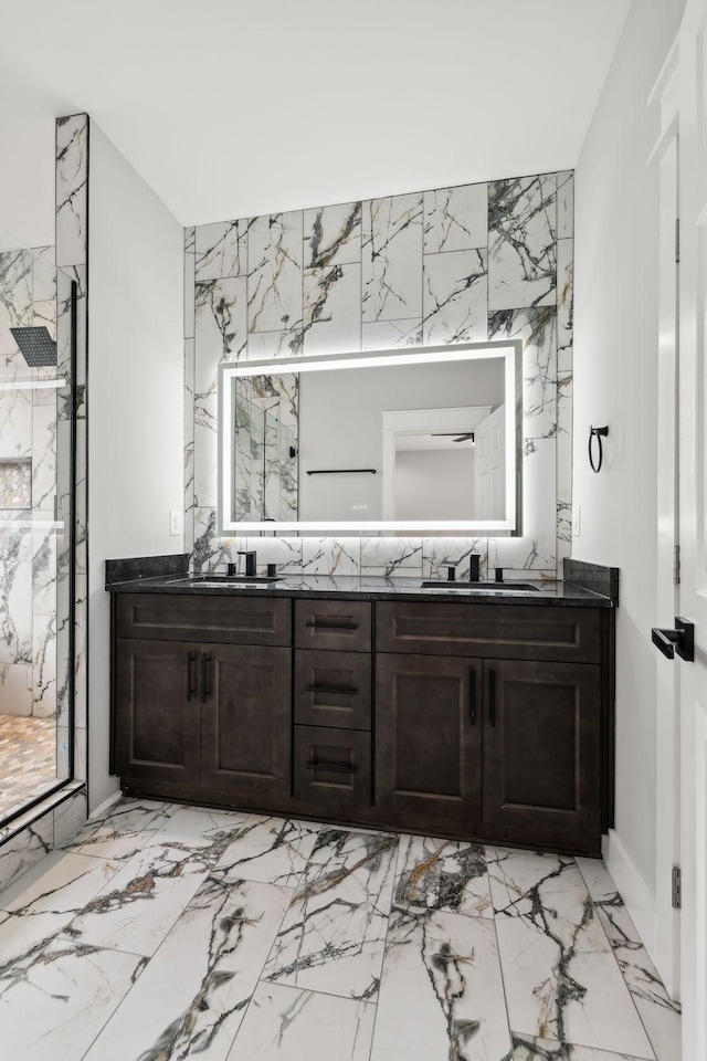 bathroom with a shower with door and vanity