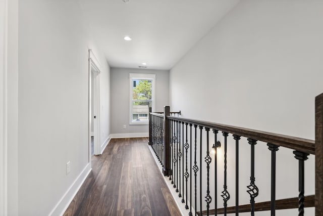 corridor with dark hardwood / wood-style flooring