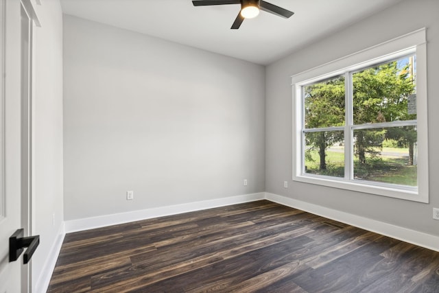 empty room with ceiling fan and dark hardwood / wood-style flooring