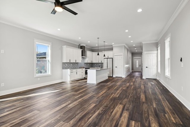 kitchen featuring backsplash, white cabinets, crown molding, hanging light fixtures, and a kitchen island