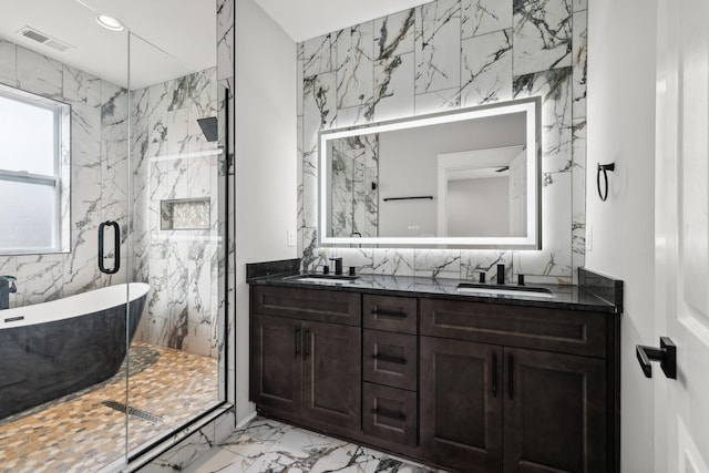 bathroom featuring vanity, tile walls, and independent shower and bath