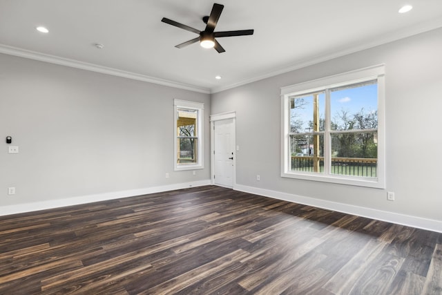 unfurnished room with plenty of natural light, dark hardwood / wood-style floors, and ornamental molding