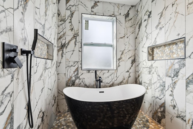 bathroom with a bath and tile walls