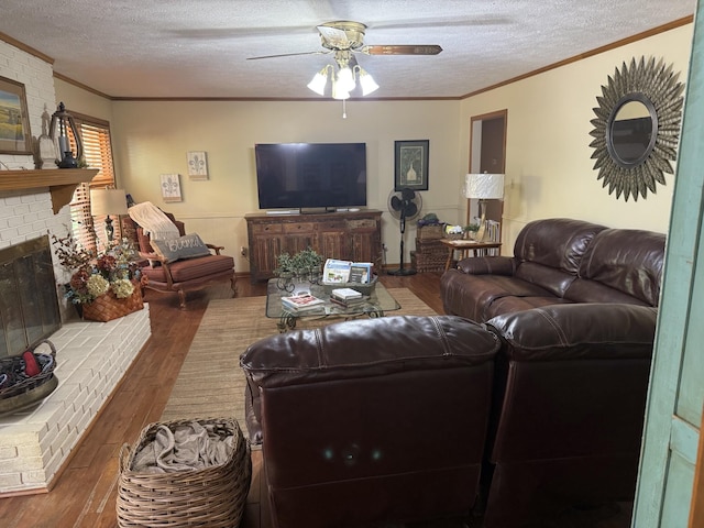 living room featuring a textured ceiling, a fireplace, ceiling fan, and dark wood-type flooring