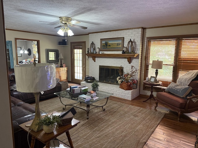 living room featuring plenty of natural light, wood-type flooring, and a textured ceiling