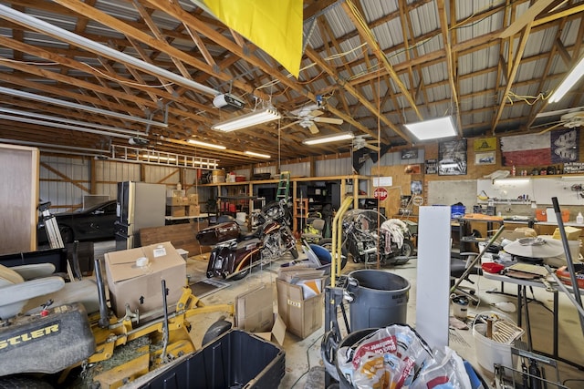 garage with stainless steel refrigerator and a garage door opener