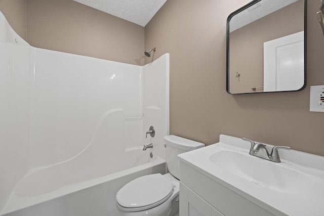 full bathroom with washtub / shower combination, vanity, a textured ceiling, and toilet