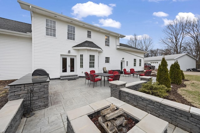 rear view of house with french doors, area for grilling, and a patio area