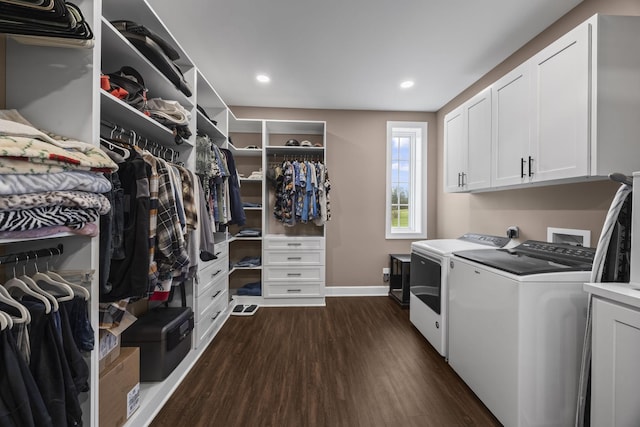 laundry room with cabinets, dark hardwood / wood-style floors, and washing machine and clothes dryer