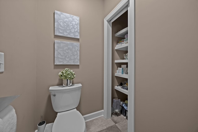 bathroom with built in features and toilet