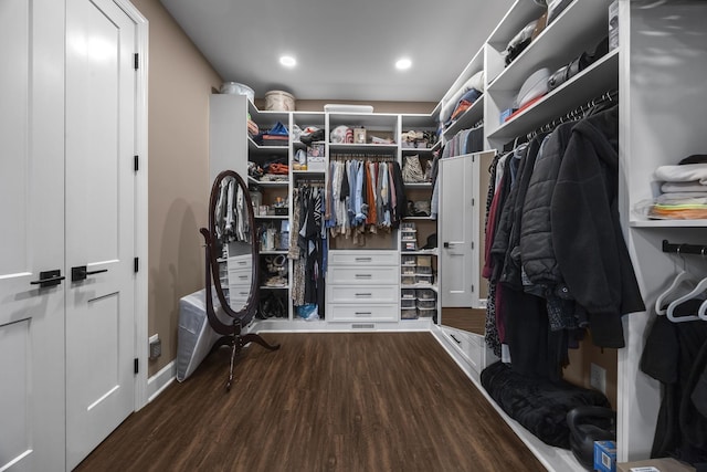 walk in closet with dark hardwood / wood-style flooring