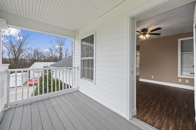 wooden terrace featuring ceiling fan