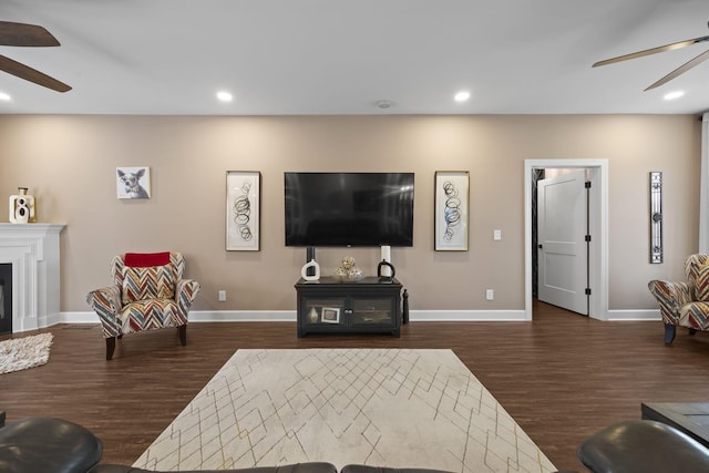 living room featuring ceiling fan and dark wood-type flooring