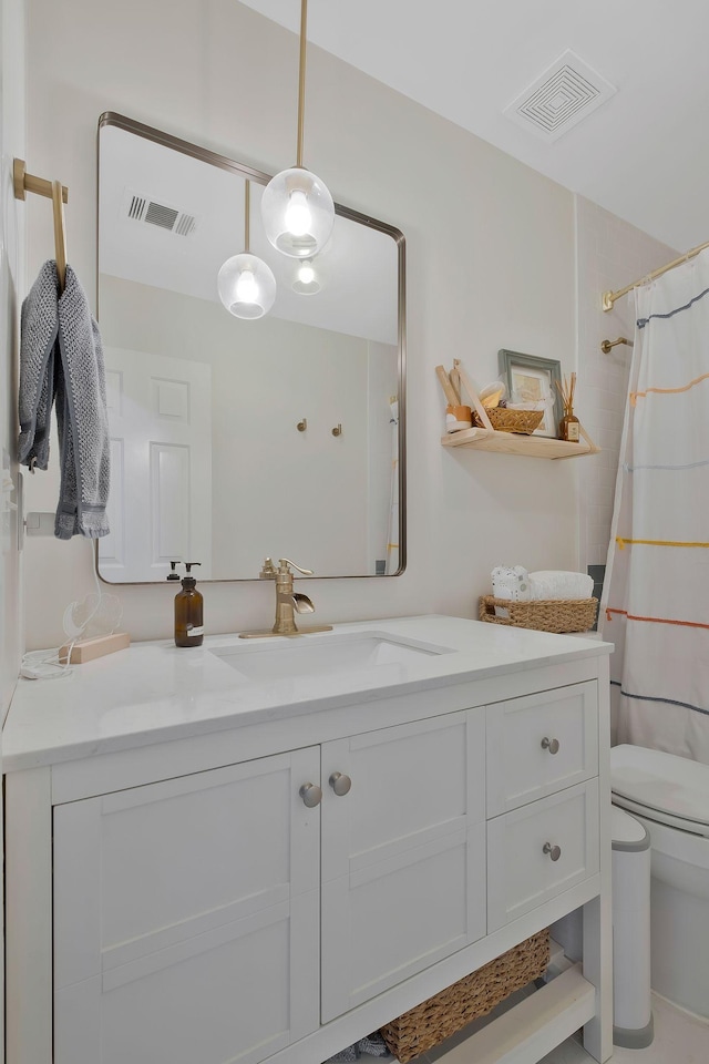 bathroom featuring vanity, toilet, and walk in shower