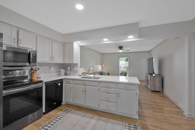 kitchen with white cabinetry, sink, stainless steel appliances, kitchen peninsula, and light wood-type flooring