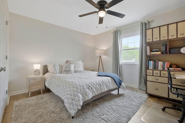 bedroom with ceiling fan and light hardwood / wood-style flooring