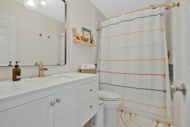 bathroom featuring vanity, toilet, and curtained shower