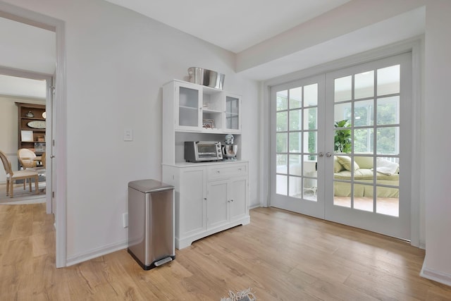 doorway to outside featuring light hardwood / wood-style floors and french doors